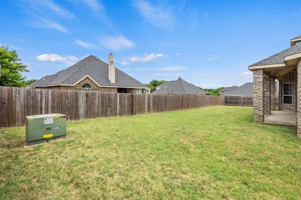 206 White Rock Court, Ovilla, TX 75154 Backyard featuring a lawn, privacy wood fencing, and a concrete patio