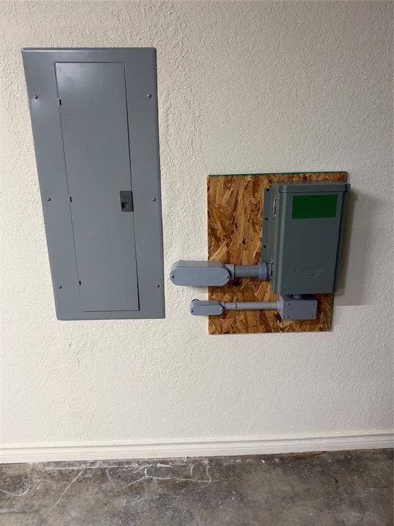 1158 County Road 141, Kaufman, TX 75142 Electrical panel featuring a flush-mount enclosure and an externally mounted secondary disconnect box on an oriented strand board backing