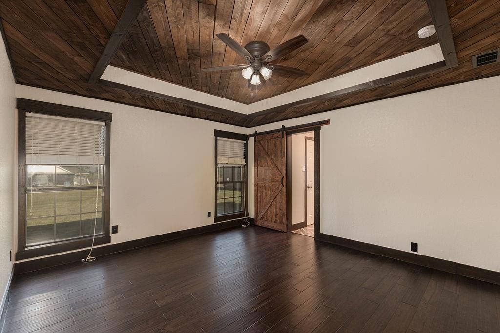 1158 County Road 141, Kaufman, TX 75142 The primary bedroom features a wooden tray ceiling