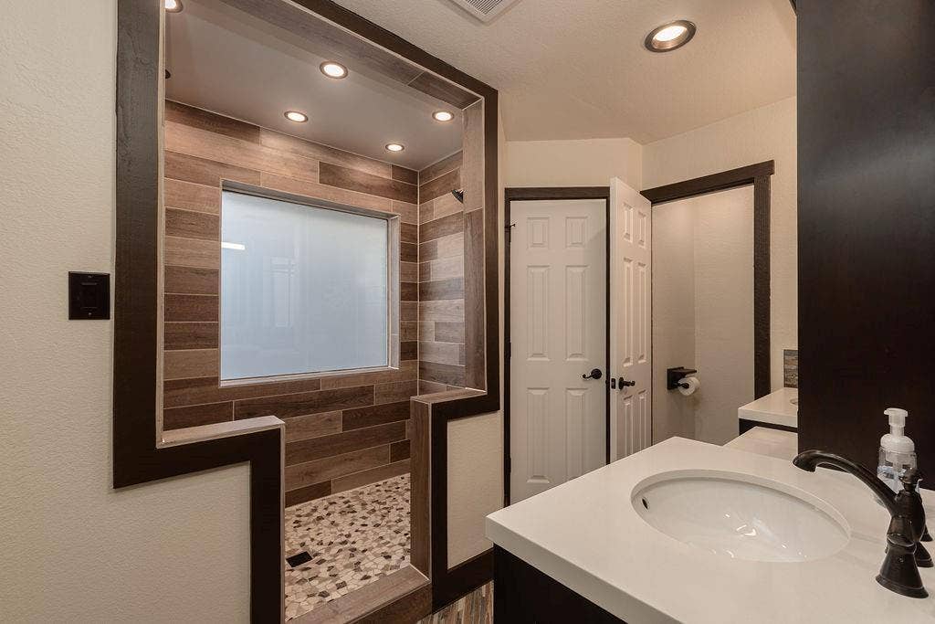 1158 County Road 141, Kaufman, TX 75142 The ensuite primary bathroom features a large walk-in shower
