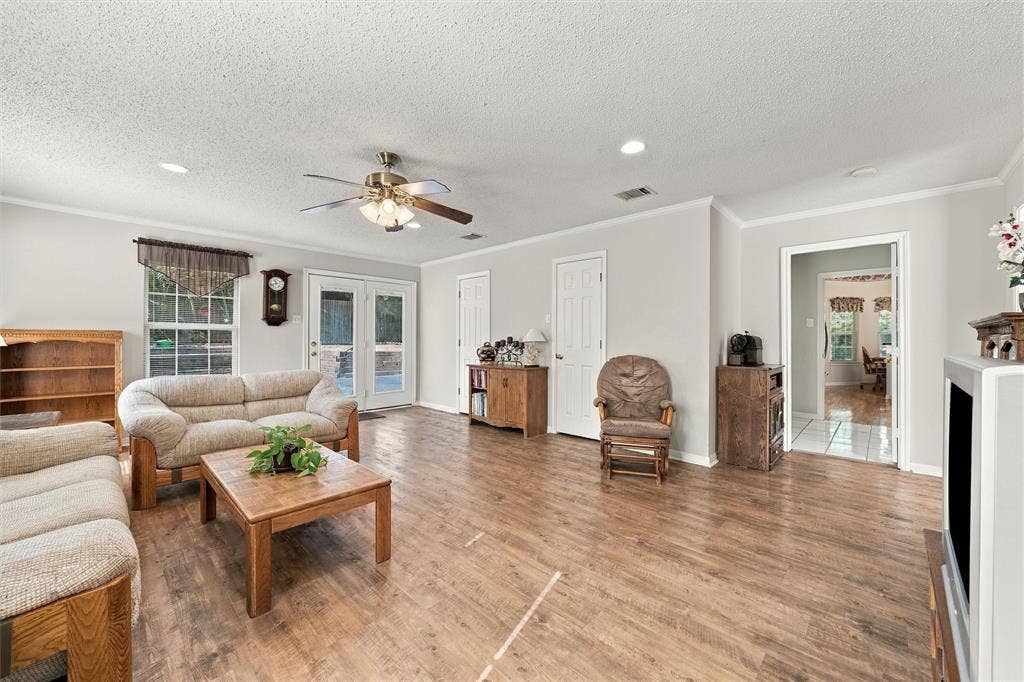 5030 Bosque Ridge Road, Crawford, TX 76638 Living area featuring wood-finish flooring, recessed lighting, a ceiling fan with integrated light fixture, and double glass-paned doors