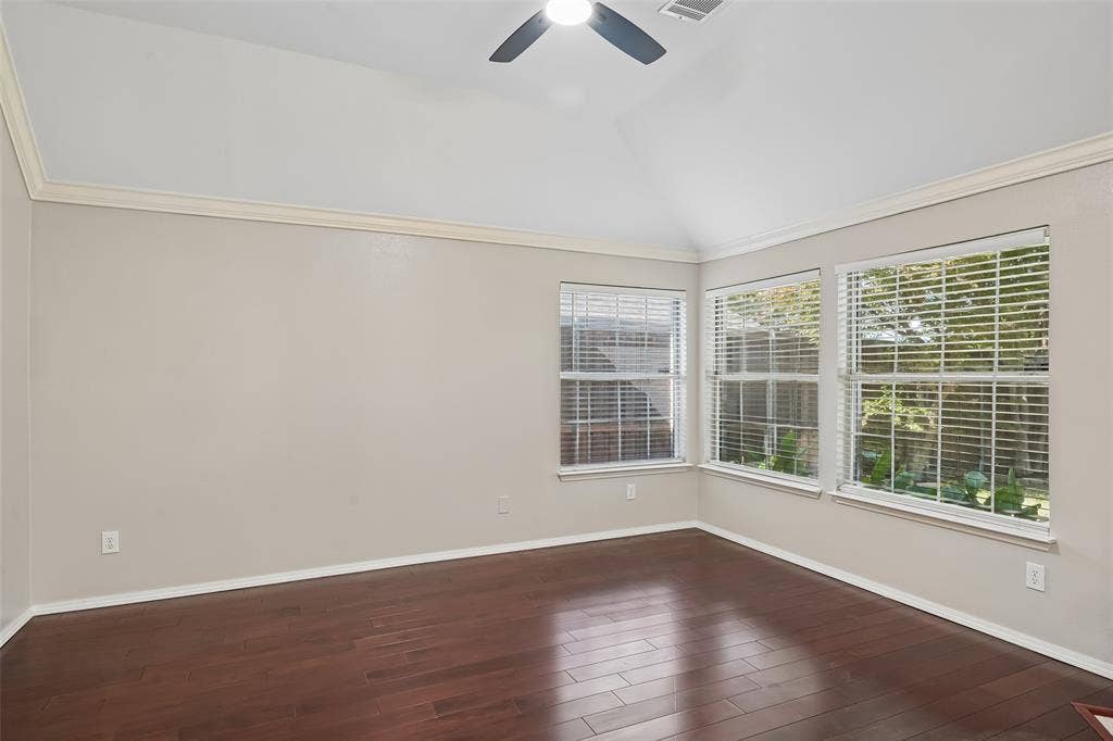 3837 Pine Valley Drive, Plano, TX 75025 Vaulted ceilings with crown molding, wood-finish flooring, and multiple windows with horizontal blinds