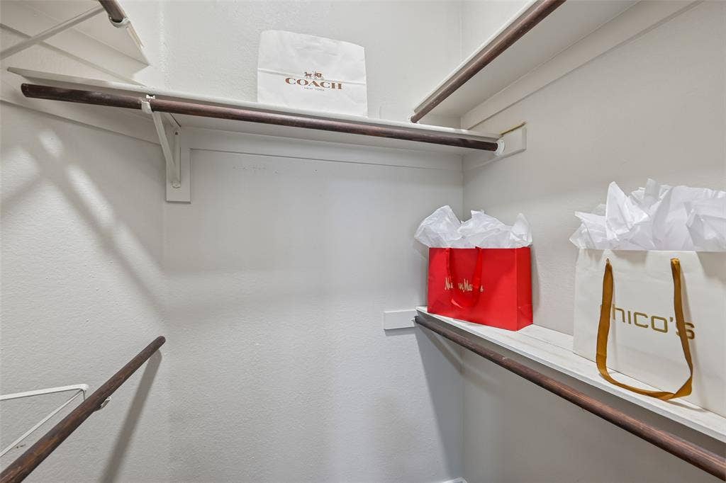 3837 Pine Valley Drive, Plano, TX 75025 Walk-in closet featuring multi-level wood shelving and integrated hanging rods