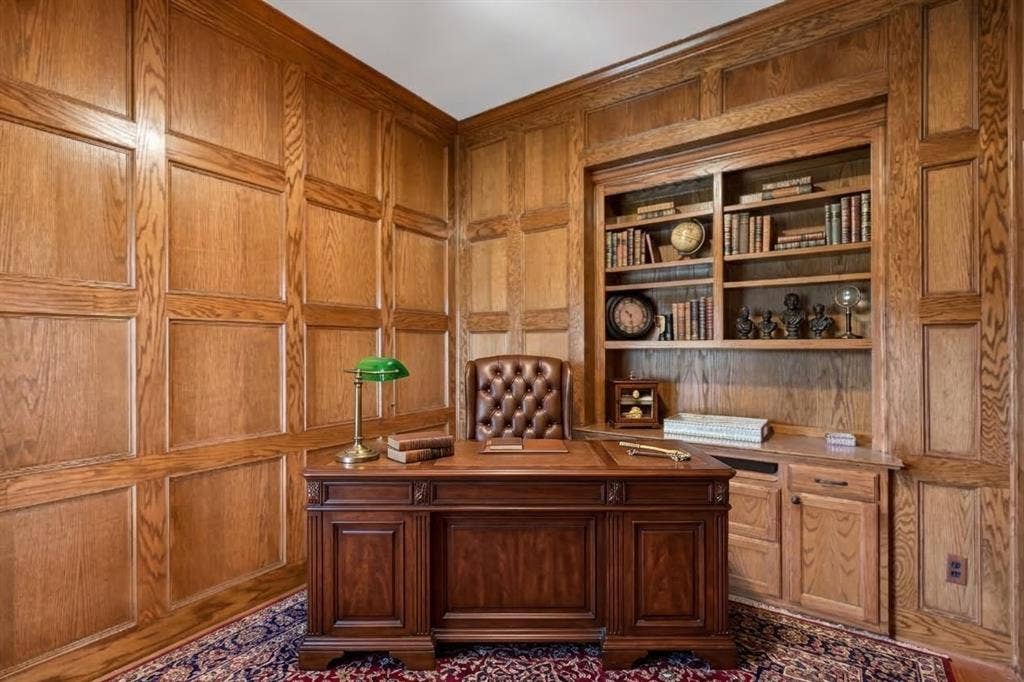 3837 Pine Valley Drive, Plano, TX 75025 Wood-paneled walls with decorative wainscoting and custom built-in cabinetry featuring integrated shelving and lower storage drawers