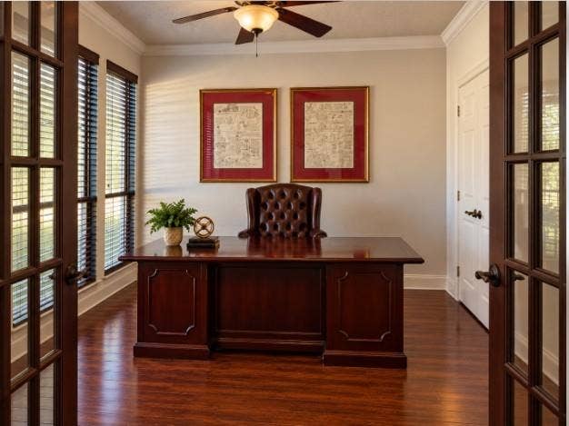 Room featuring hardwood flooring, double French doors with glass panes, crown molding, and a ceiling fan with light fixture
