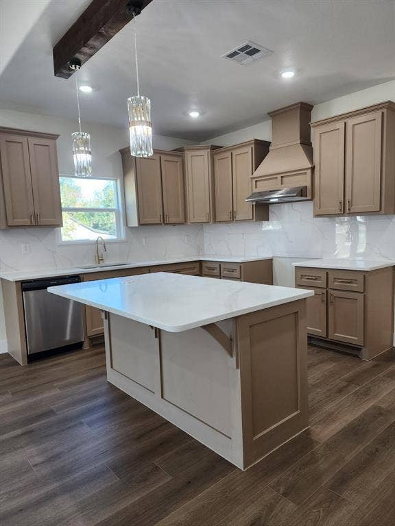 Kitchen featuring cabinetry with a matte finish, white countertops with veining, a stainless steel range hood, wood-finish flooring, and a decorative exposed ceiling beam