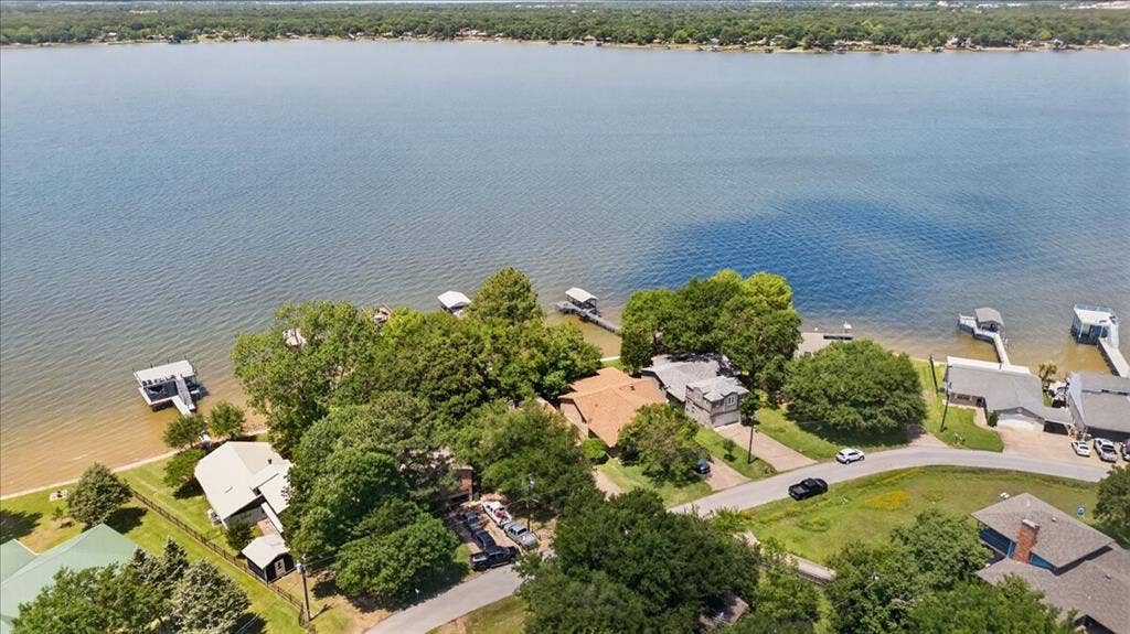 10118 Lakeview Street, Payne Springs, TX 75156 Aerial perspective featuring direct water frontage, private boat dock, shoreline access, and mature tree canopy