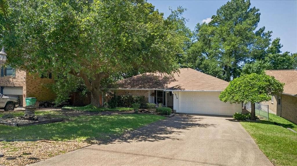 10118 Lakeview Street, Payne Springs, TX 75156 Single-story brick exterior featuring an attached two-car garage, concrete driveway, and mature trees