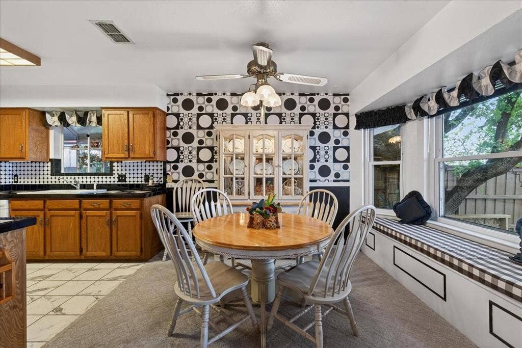 10118 Lakeview Street, Payne Springs, TX 75156 Dining area featuring a built-in china cabinet, window seat, ceiling fan with integrated lighting, and tile flooring