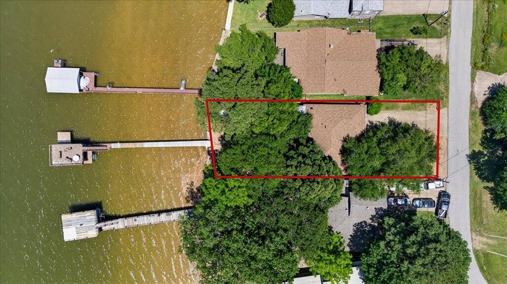 10118 Lakeview Street, Payne Springs, TX 75156 Aerial perspective of waterfront property featuring a private boat dock, extensive shoreline frontage, and mature tree canopy