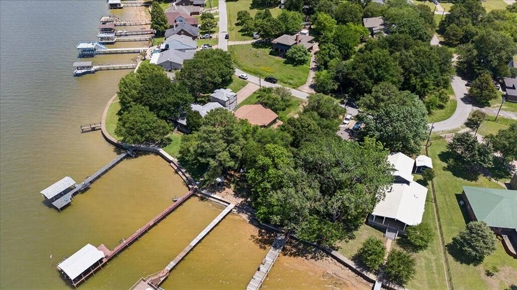10118 Lakeview Street, Payne Springs, TX 75156 Aerial perspective of waterfront property featuring a private boat dock, natural shoreline, mature trees, and paved access