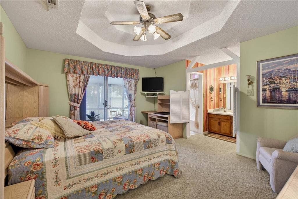 10118 Lakeview Street, Payne Springs, TX 75156 Octagonal tray ceiling with a central multi-light fan, sliding glass door, and built-in wood cabinetry