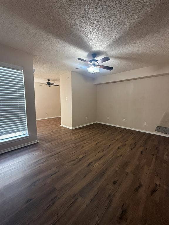 Wood-finish flooring, dual ceiling fans with integrated lighting, and neutral wall tones