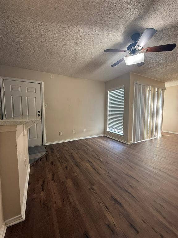 Wood-finish flooring, ceiling fan with integrated light fixture, and vertical blinds
