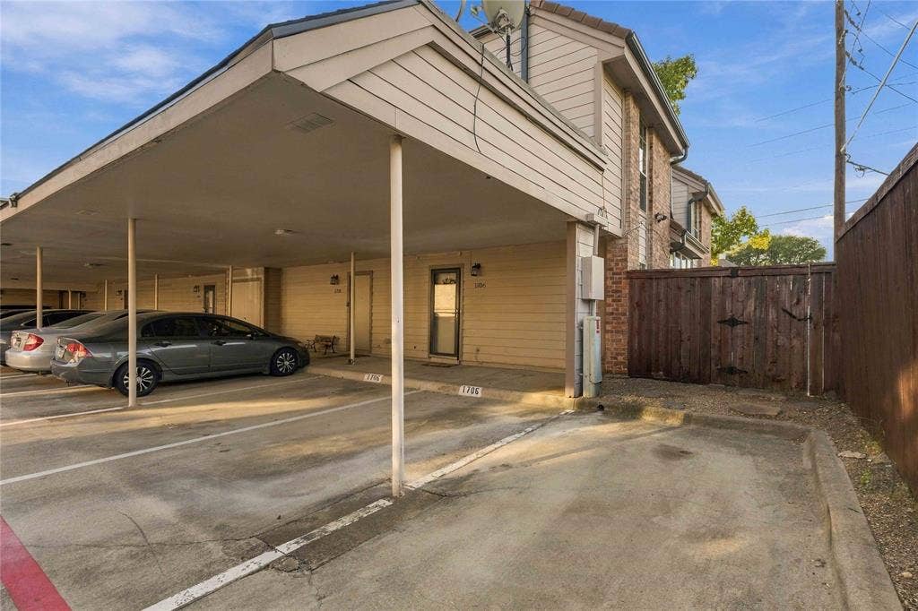 18240 Midway Road, #1706, Dallas, TX 75287 Exterior view featuring a two assigned covered carport parking spots plus additional guest spot and a wood privacy fence