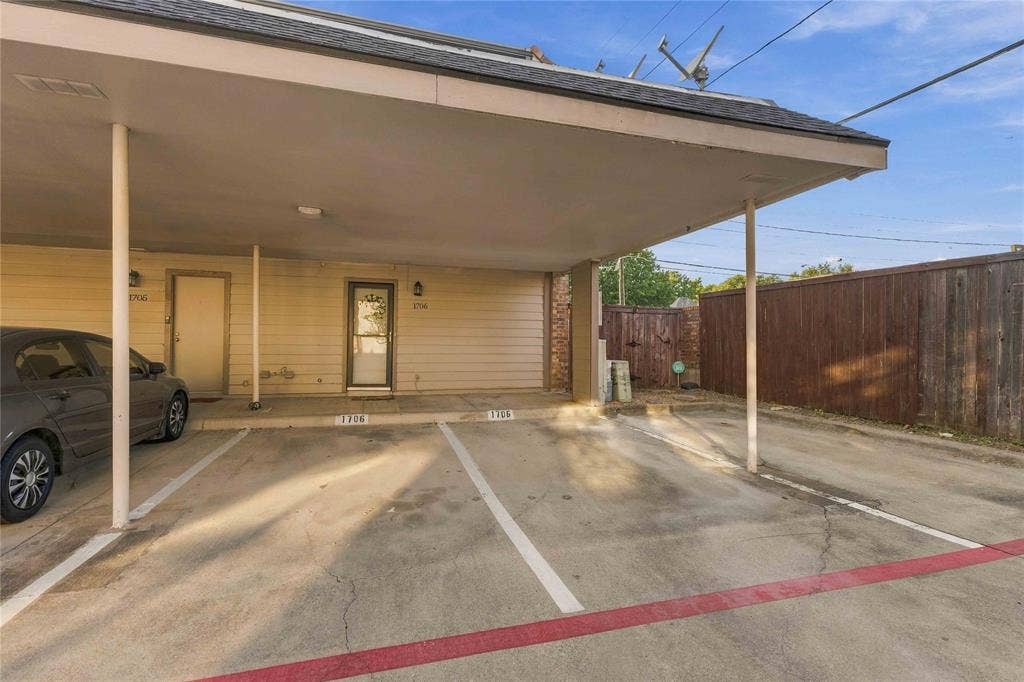 18240 Midway Road, #1706, Dallas, TX 75287 Exterior view featuring a two assigned covered carport parking spots plus additional guest spot and a wood privacy fence