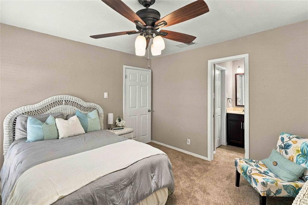 18240 Midway Road, #1706, Dallas, TX 75287 Room featuring wall-to-wall carpeting, a dark-finish ceiling fan with integrated lighting, and a six-panel door