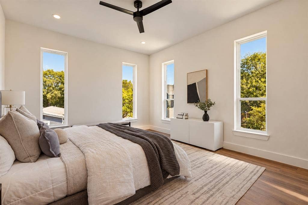 Wood-finish flooring, recessed lighting, and a contemporary ceiling fan