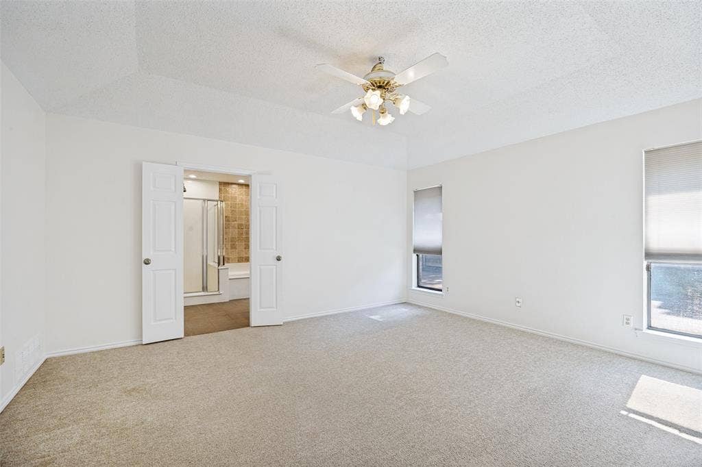 6627 Sawmill Road, Dallas, TX 75252 Tray ceiling, central ceiling fan with multi-light fixture, dual interior doors, and dual windows with roller shades
