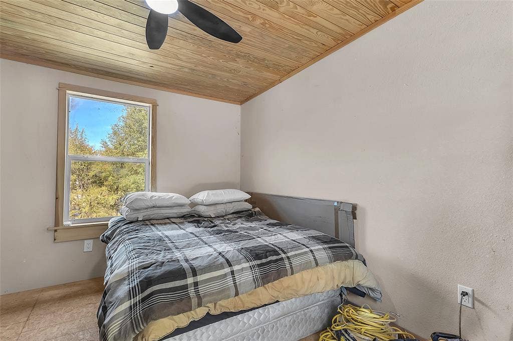 131 Baff Bay Drive, Gun Barrel City, TX 75156 Bedroom with wood plank ceiling, ceiling fan, and tree view window