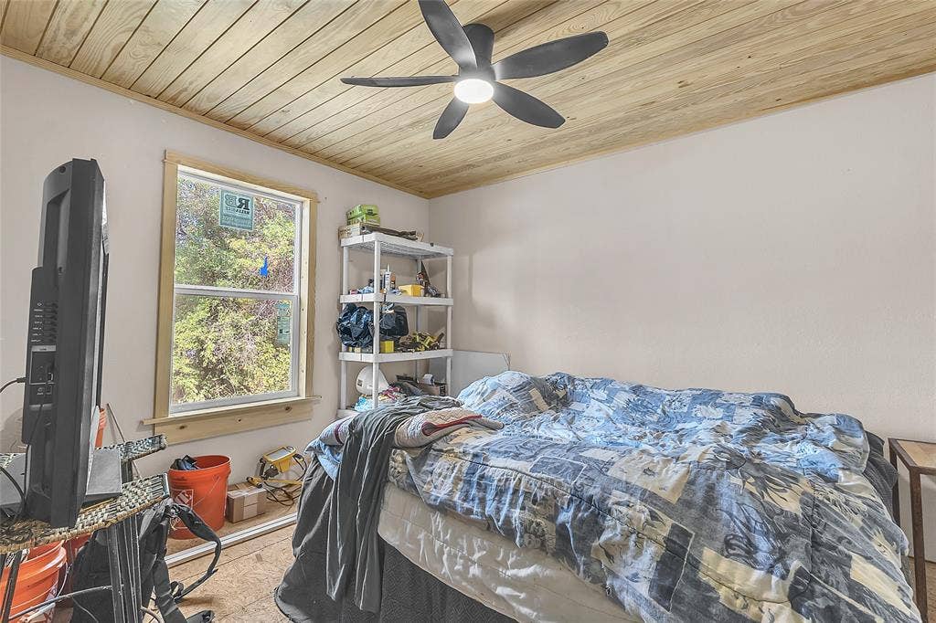 131 Baff Bay Drive, Gun Barrel City, TX 75156 Bedroom with wood plank ceiling, ceiling fan, and window