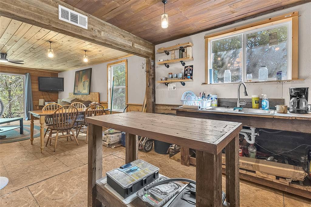 131 Baff Bay Drive, Gun Barrel City, TX 75156 Kitchen sink under window with open shelving and living area beyond