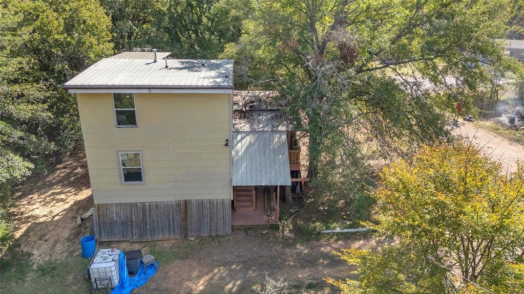 131 Baff Bay Drive, Gun Barrel City, TX 75156 Aerial of two-story home with metal roof and covered rear deck