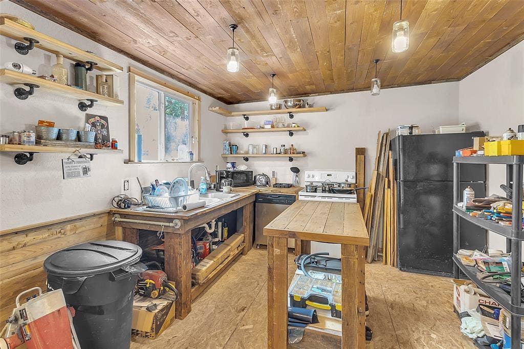 131 Baff Bay Drive, Gun Barrel City, TX 75156 Kitchen with open wood shelving, wood island, and pendant lights