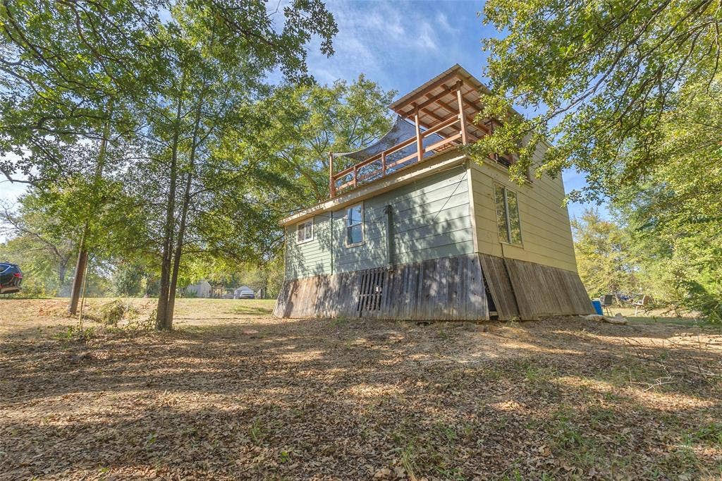 131 Baff Bay Drive, Gun Barrel City, TX 75156 Exterior with upper covered deck and mature shade trees