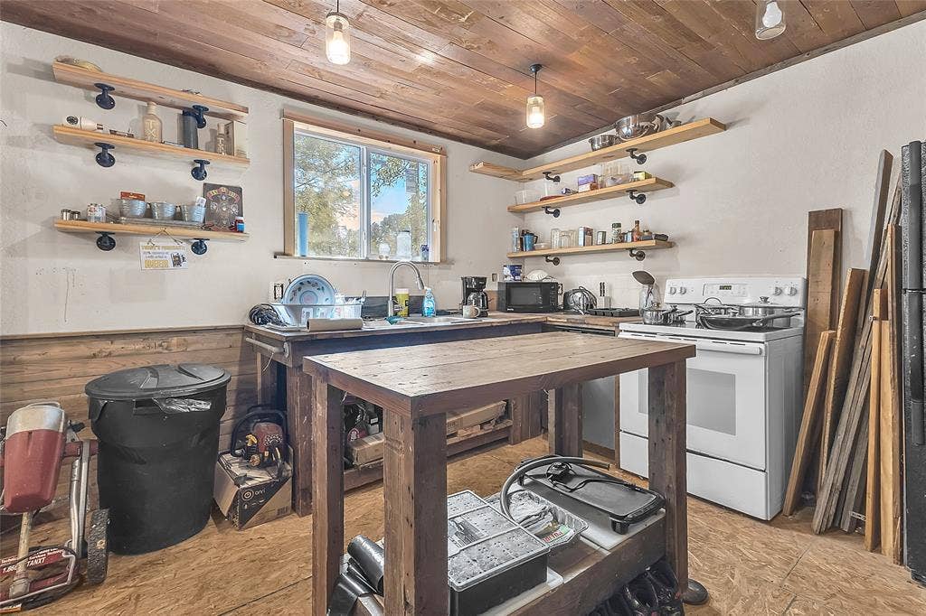 131 Baff Bay Drive, Gun Barrel City, TX 75156 Kitchen with white range, open shelving, and wood island
