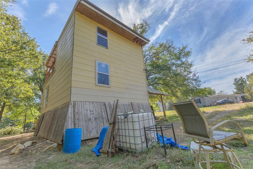 131 Baff Bay Drive, Gun Barrel City, TX 75156 Exterior side view of the two-story home and yard