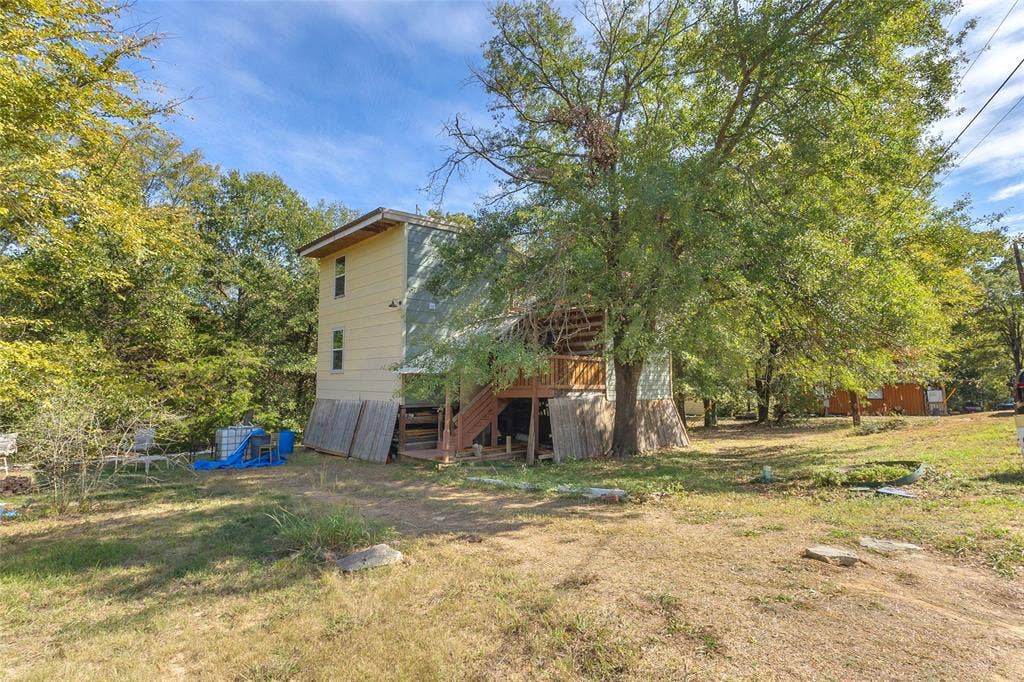 131 Baff Bay Drive, Gun Barrel City, TX 75156 Backyard with large shade tree and stairs to the deck