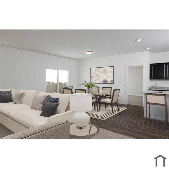 1805 Pueblo Street, Forney, TX 75126 Open-concept interior featuring wood-finish flooring, recessed lighting, and a kitchen breakfast bar with stone-surface countertop