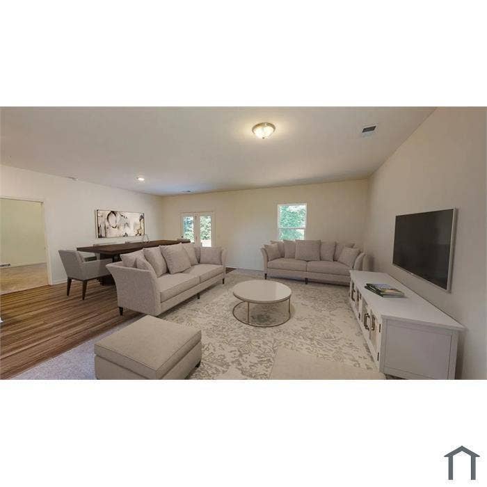 1805 Pueblo Street, Forney, TX 75126 Open-concept living space featuring wood-finish flooring, neutral wall tones, recessed lighting, and glass-paneled double doors