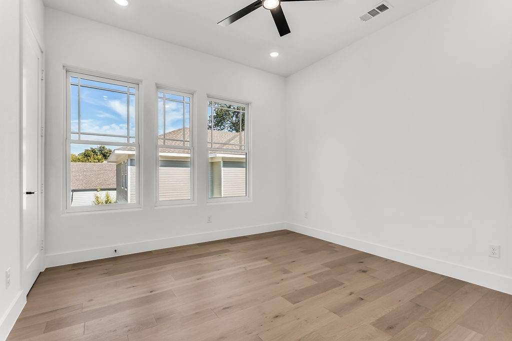 4631 Junius Street, Dallas, TX 75246 Generously sized secondary bedroom with ample closet space and natural light