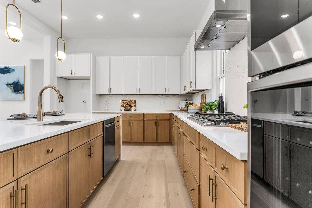4631 Junius Street, Dallas, TX 75246 Chef’s kitchen featuring Calacatta Verona quartz waterfall island, two-tone slim shaker cabinetry, and Samsung stainless appliances