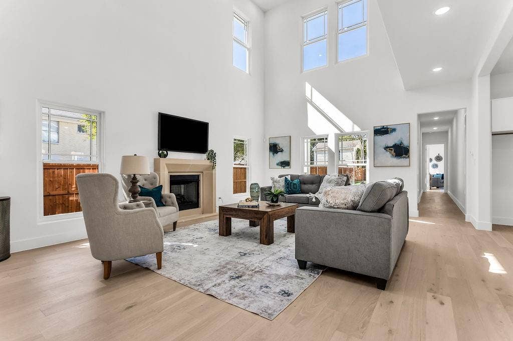 4631 Junius Street, Dallas, TX 75246 Soaring 2-story great room with gas fireplace, clerestory windows, and wide-plank white oak engineered hardwood
