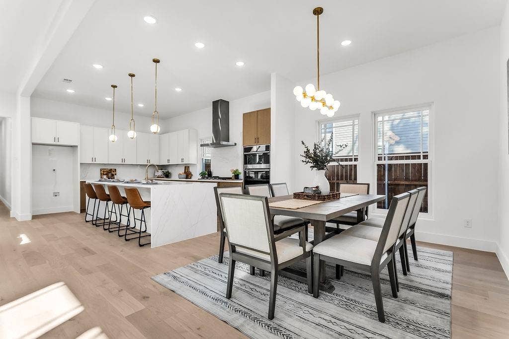 4631 Junius Street, Dallas, TX 75246 Open-concept dining seamlessly connects the kitchen, great room, and covered rear patio
