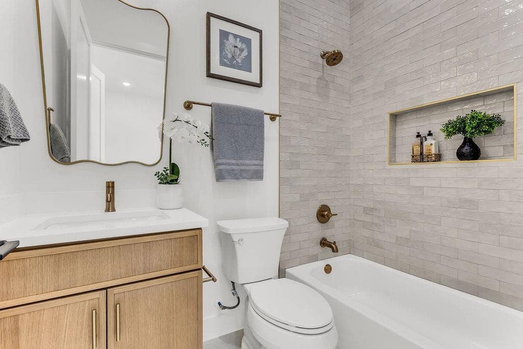 4631 Junius Street, Dallas, TX 75246 Designer full bath with quality tile work and modern fixtures — mirrors the elevated finishes found throughout the home