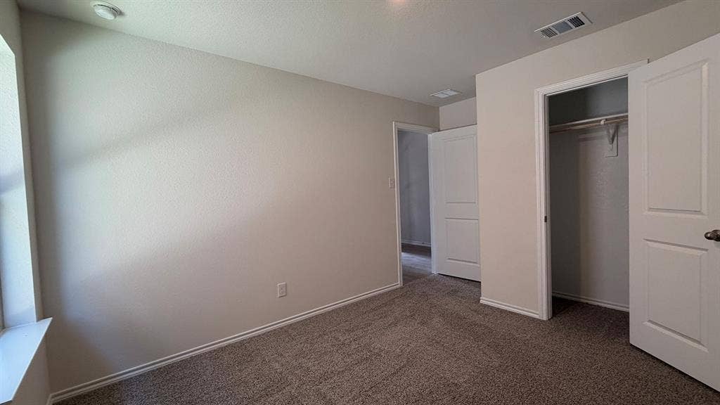 Neutral-toned carpeting paired with light-colored walls