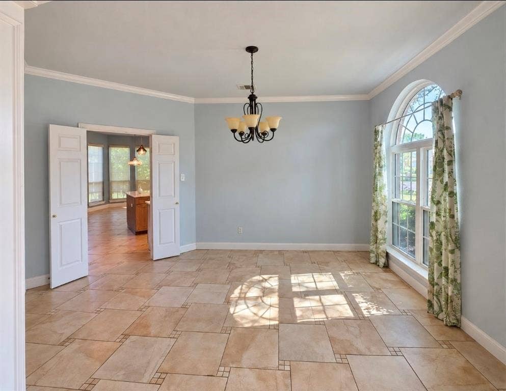 Formal room featuring ceramic tile flooring, arched window with decorative muntins, multi-arm metal chandelier, and double-panel door entry