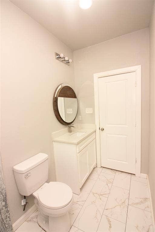 Bathroom featuring a white vanity with a neutral countertop, circular wall-mounted mirror, three-light fixture, and large-format tile flooring