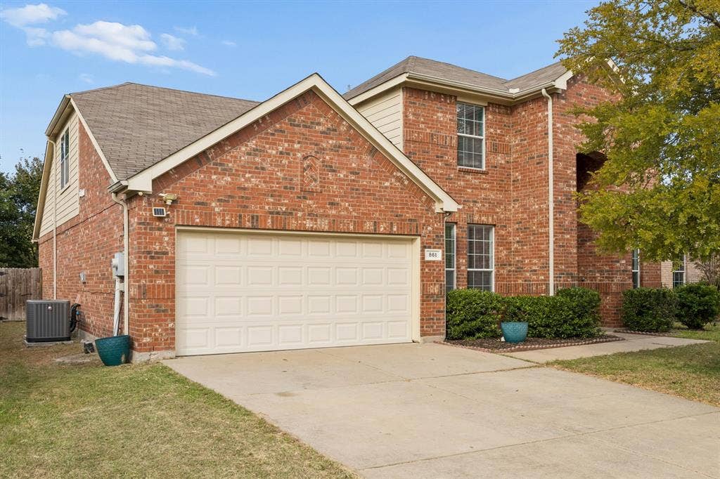 861 Crockett Drive, Lavon, TX 75166 Showcasing timeless brick construction, multiple rooflines, and an attractive two-story design, this residence offers enduring curb appeal. The spacious driveway, attached two-car garage, and established landscaping create a welcoming approach to a home designed for comfortable living and entertaining.