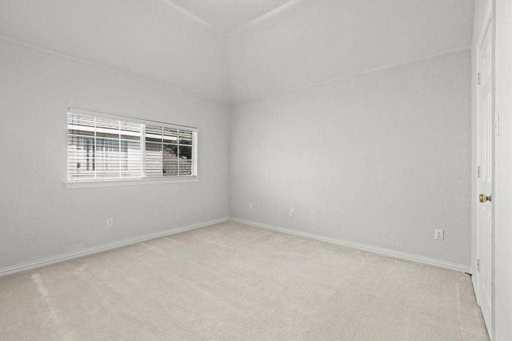 4120 Silverthorne Street, Richardson, TX 75082 Vaulted ceiling, neutral wall tones, wall-to-wall carpeting, and horizontal window blinds
