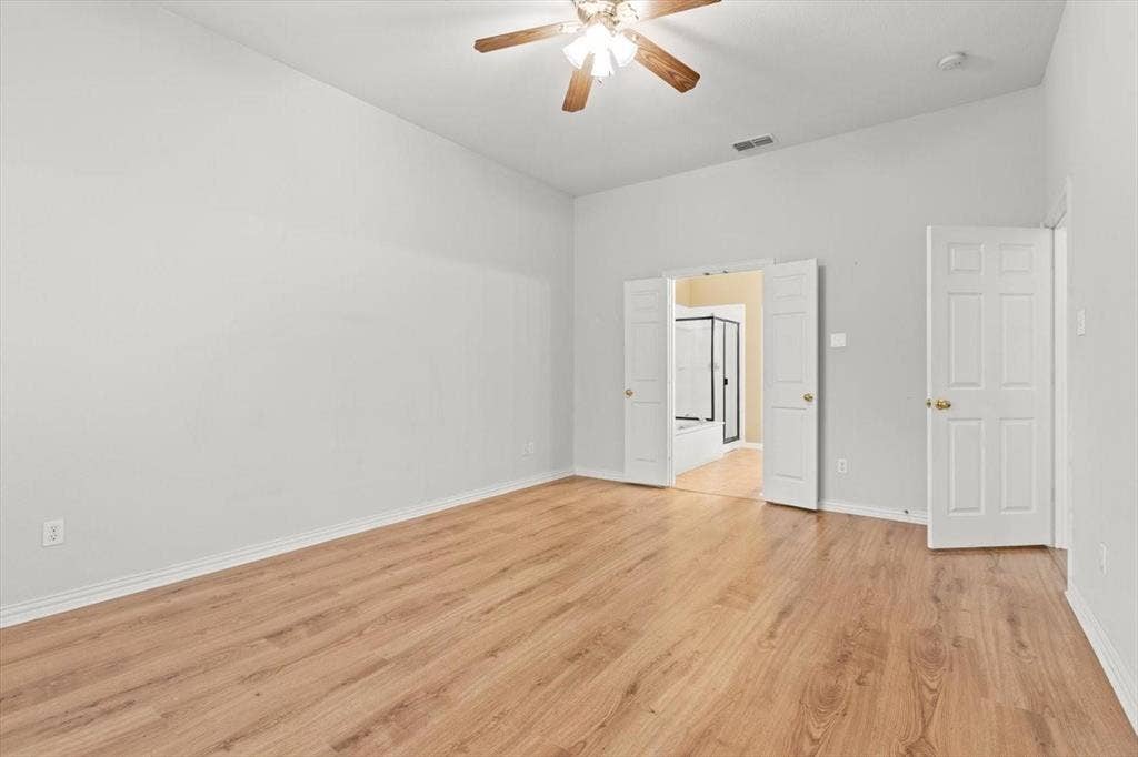 4120 Silverthorne Street, Richardson, TX 75082 High-vaulted ceilings featuring a central wood-finish ceiling fan, wood-finish flooring, and double-door entry