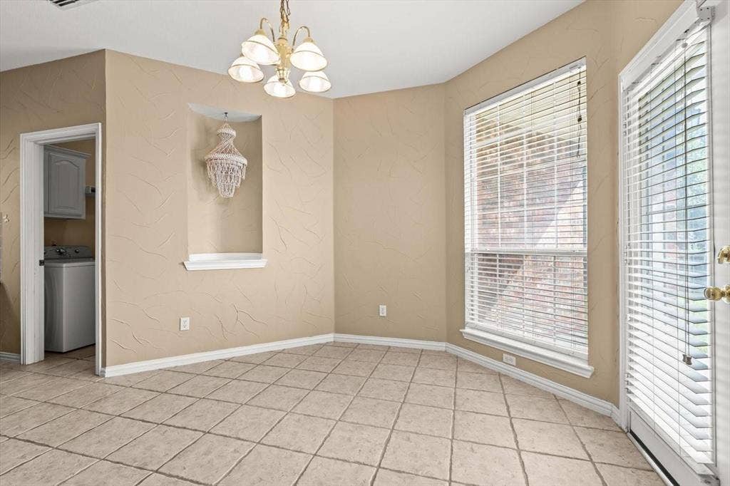 4120 Silverthorne Street, Richardson, TX 75082 Tiled flooring, built-in wall niche, multi-light chandelier, and expansive windows