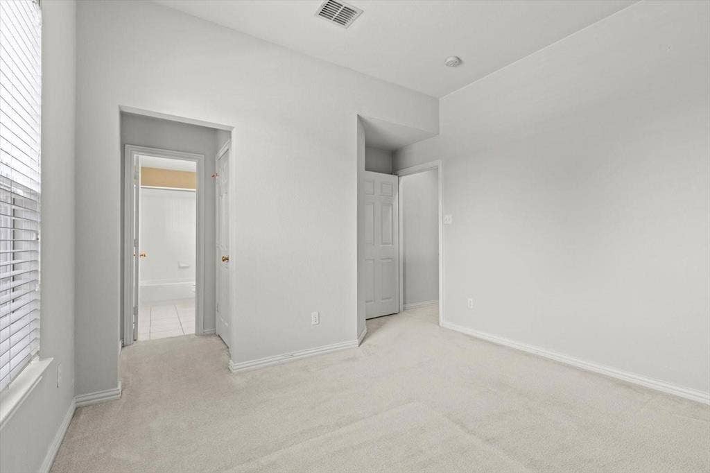 4120 Silverthorne Street, Richardson, TX 75082 Room featuring neutral wall tones, high ceilings, carpeted flooring, and white paneled interior doors