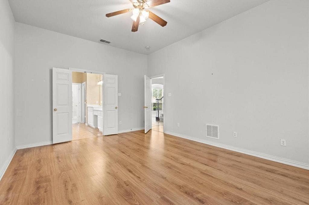 4120 Silverthorne Street, Richardson, TX 75082 Interior room featuring high ceilings, wood-finish flooring, and a ceiling fan with integrated lighting