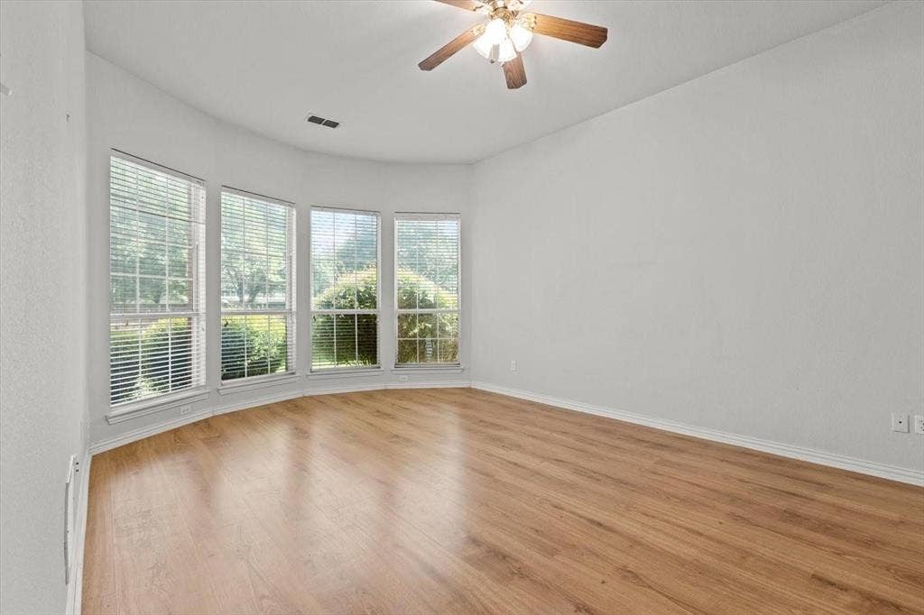 4120 Silverthorne Street, Richardson, TX 75082 Bay window featuring four multi-pane windows, wood-finish flooring, and a ceiling-mounted light fixture with a central fan