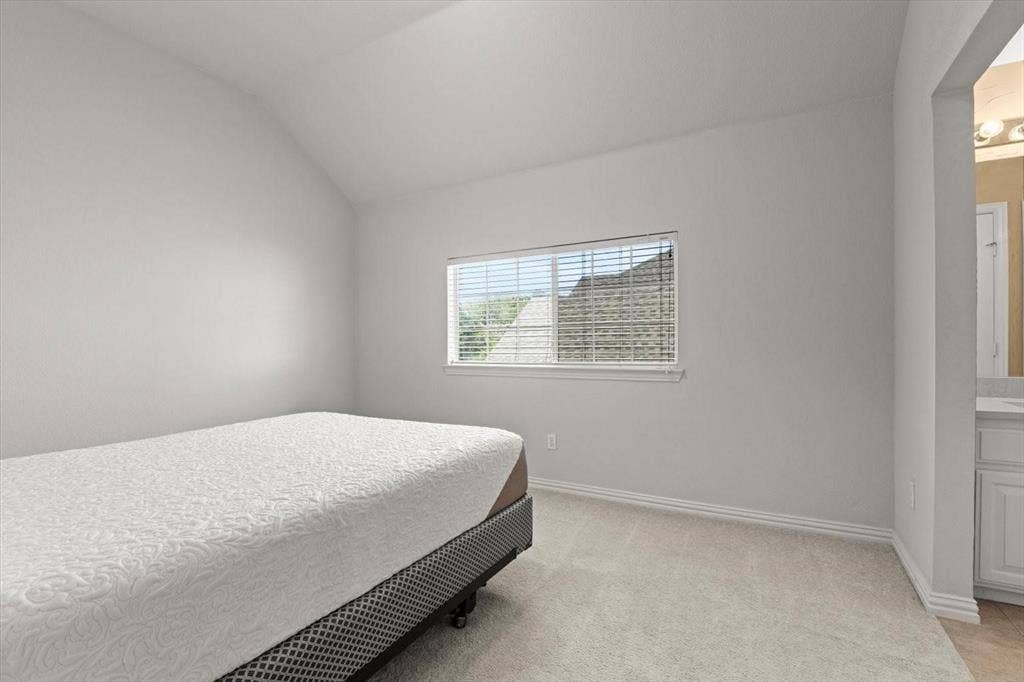 4120 Silverthorne Street, Richardson, TX 75082 Vaulted ceiling, neutral wall tones, wall-to-wall carpeting, and a rectangular window with horizontal blinds